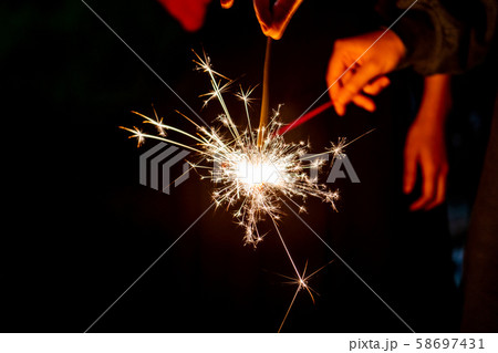 手持ち花火を火種にしての写真素材