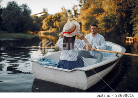 Love couple boating on lake at summer day Love couple boating on lake at summer day 58698016
