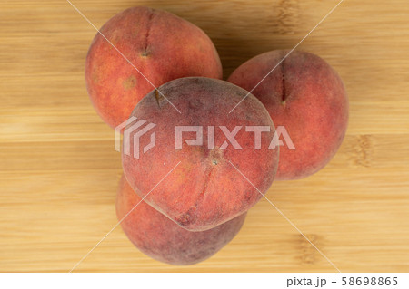 Sweet red peach on light wood 58698865