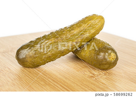 Sour green pickles isolated on white Sour green pickles isolated on white 58699262