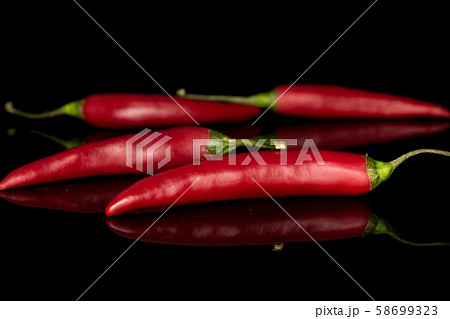 Red hot cayenne chili isolated on black glass 58699323