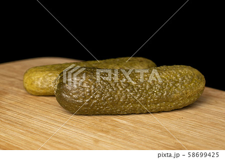 Sour green pickles isolated on black glass 58699425