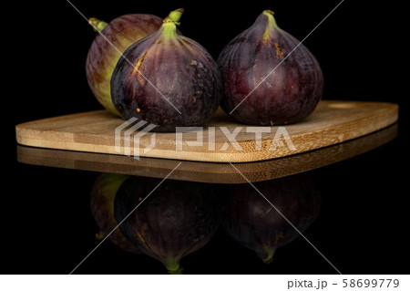 Sweet purple fig isolated on black glass Sweet purple fig isolated on black glass 58699779