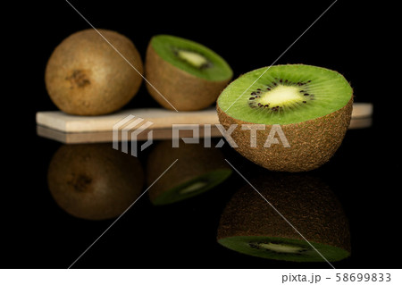 Exotic brown kiwifruit isolated on black glass Exotic brown kiwifruit isolated on black glass 58699833