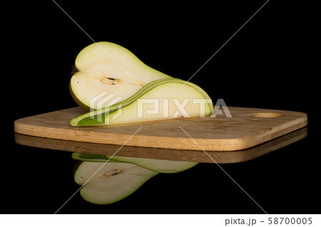 Fresh green pear isolated on black glass Fresh green pear isolated on black glass 58700005