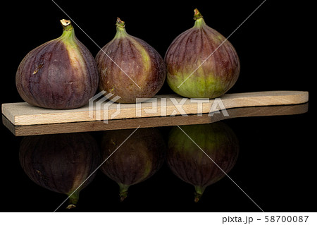 Sweet purple fig isolated on black glass Sweet purple fig isolated on black glass 58700087