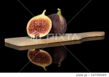 Sweet purple fig isolated on black glass 58700089
