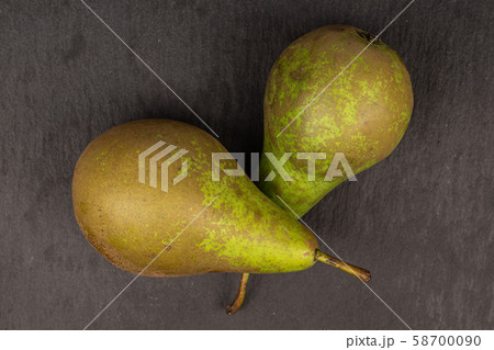 Fresh green pear on grey stone 58700090