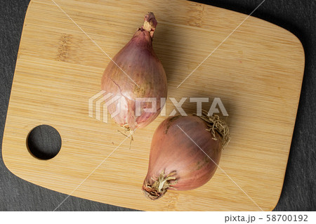 Fresh brown shallot on grey stone 58700192