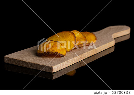 Dried vegetable chips isolated on black glass Dried vegetable chips isolated on black glass 58700338