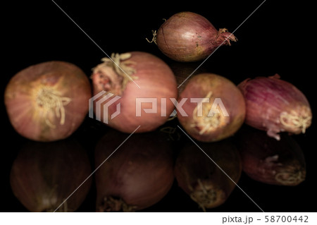 Fresh brown shallot isolated on black glass 58700442