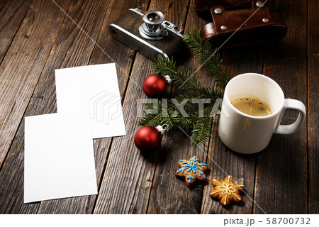Photos, camera, pine tree branch and cup of coffee Photos, camera, pine tree branch and cup of coffee 58700732