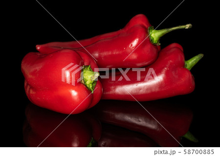 Sweet red bell pepper isolated on black glass 58700885
