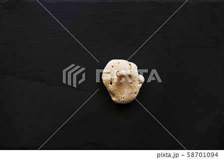 White coral on dark stone background. White coral on dark stone background. 58701094