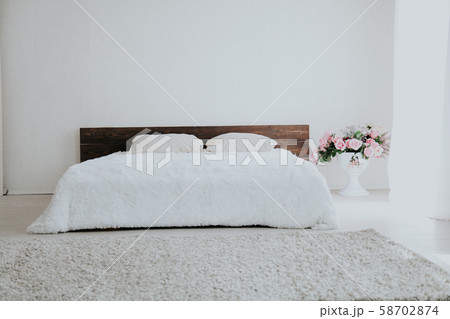 Interior white bedroom this morning with bed 58702874