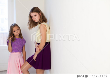 Two fashionable little sister girls of different ages Two fashionable little sister girls of different ages 58704485