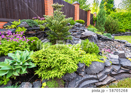 Natural stone landscaping in backyard in summer 58705268