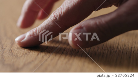 man hand touch oil finished oak wood surface 58705524