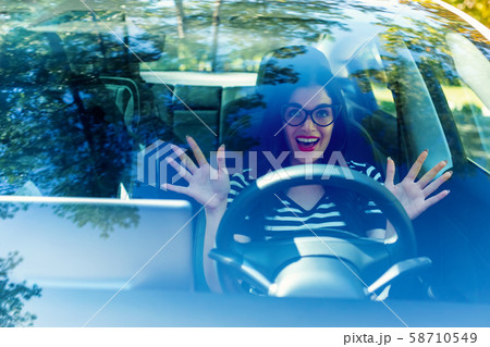 Woman in an autonomous vehicle 58710549