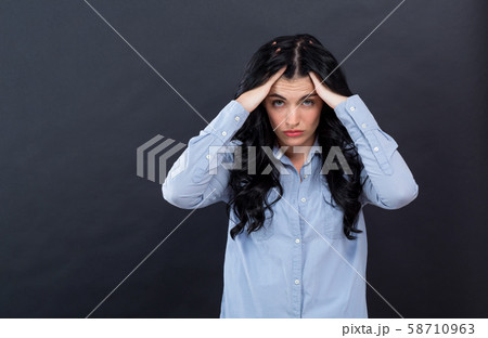 Young woman suffering from headache 58710963