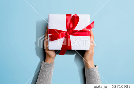 Person holding a Christmast gift box 58710985