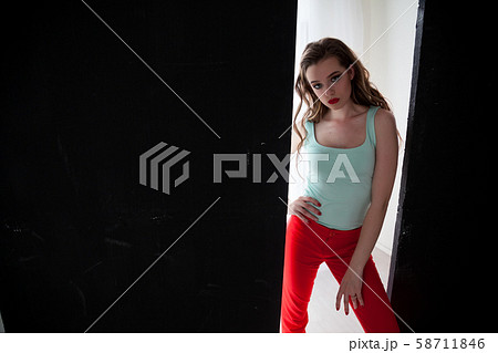Portrait of a beautiful woman with long hair sitting on the floor Portrait of a beautiful woman with long hair sitting on the floor 58711846