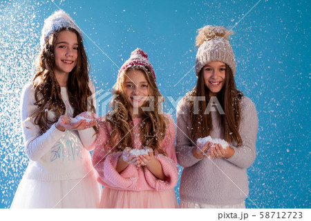Three girl girlfriends play with snow in winter 58712723