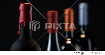 Set of collars red wine bottles isolated on black background Set of collars red wine bottles isolated on black background 58716513