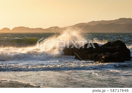 Big wave from hard wind touching big rock of Baker 58717646