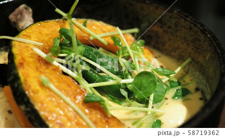 Close-up images of yellow color soup curry with chicken, pork and vegetable in bowl which famous traditional food menu and only found in Hokkaido Sapporo district of Japan Close-up images of yellow color soup curry with chicken, pork and vegetable in bowl which famous traditional food menu and only found in Hokkaido Sapporo district of Japan 58719362
