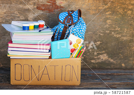 Donation box with school supplies on old wooden Donation box with school supplies on old wooden 58721587