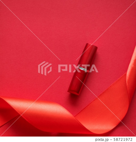 Luxury lipstick and silk ribbon on red holiday 58721972
