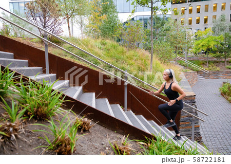Fit sports women running interval workout in stairs in city park 58722181
