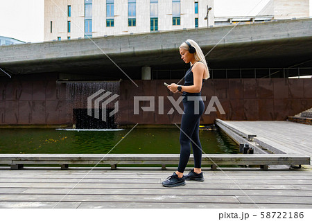 Woman runner start music on smartphone before running 58722186