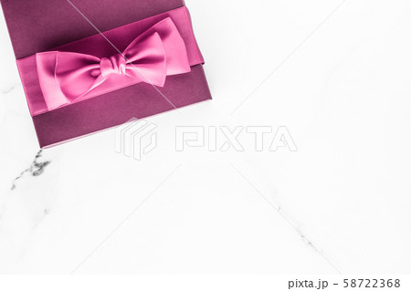 Pink gift box with silk bow on marble background, Pink gift box with silk bow on marble background, 58722368