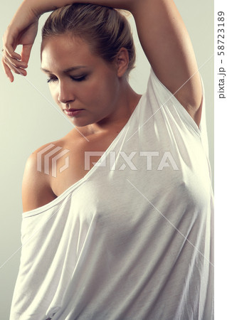 Studio portrait of beautiful woman with blonde hair and white t-shirt Studio portrait of beautiful woman with blonde hair and white t-shirt 58723189
