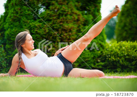 Expectant Woman Performing Side Reclining Leg Lift On Yoga Mat Expectant Woman Performing Side Reclining Leg Lift On Yoga Mat 58723870
