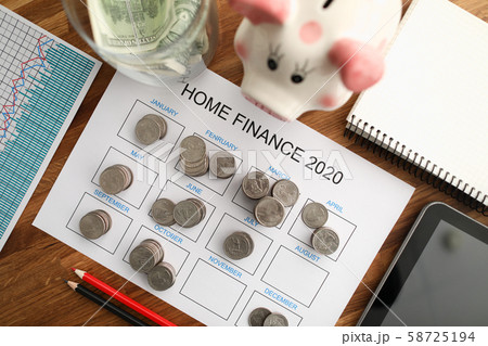 Top view of coin tover with paper calendar against Top view of coin tover with paper calendar against 58725194