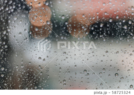 Blurred rainy window with red bokeh light 58725324