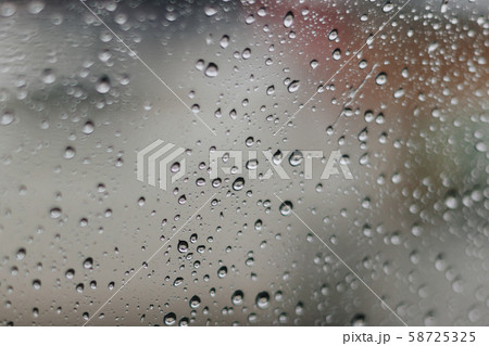 Blurred rainy window with red bokeh light 58725325