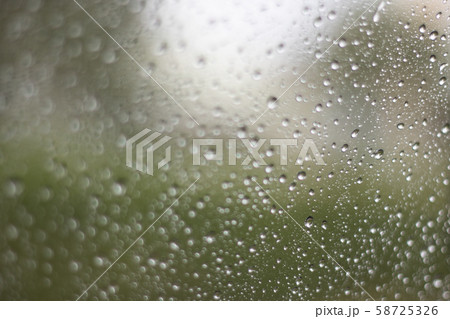 Blurred rainy window with red bokeh light 58725326
