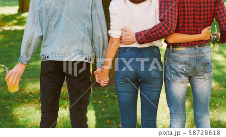 polyamorous relationship woman standing two guys polyamorous relationship woman standing two guys 58728618