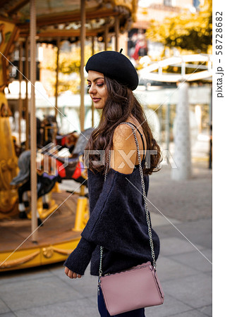 woman dressed in retro style walking around the city. 58728682