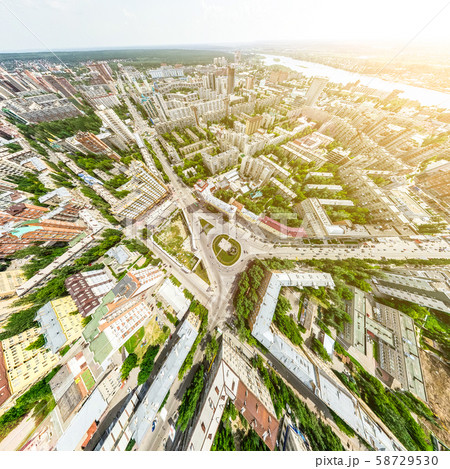 Aerial city view with crossroads and roads, houses, buildings, parks and parking lots. Sunny summer Aerial city view with crossroads and roads, houses, buildings, parks and parking lots. Sunny summer 58729530