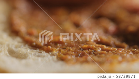 Extreme closeup of ciabatta slice with red pesto 58729971
