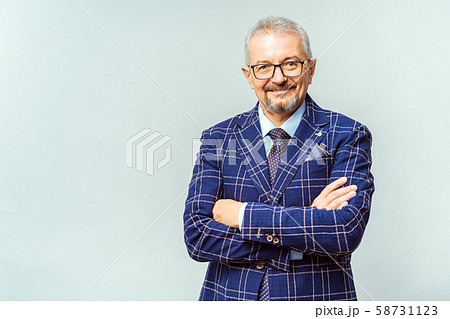 Portrait of a mature businessman wearing glasses on white background. Happy senior man looking at 58731123