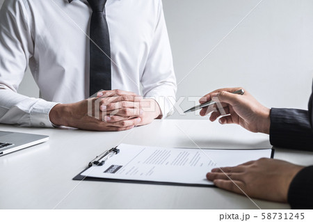 Employer or committee holding reading a resume Employer or committee holding reading a resume 58731245