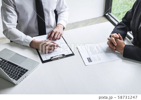 Employer or committee holding reading a resume 58731247