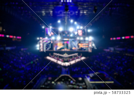 Blurred background of an esports event - Big illuminated main stage of a computer games tournament 58733325