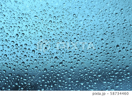 Water drops on glass, green background Water drops on glass, green background 58734460